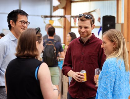 Douglas Sloan, Gabriel Ng and other staff members in conversation