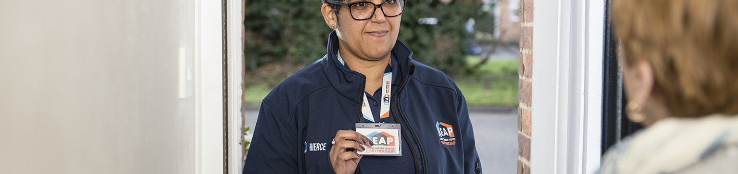 Woman standing in doorway showing her staff pass