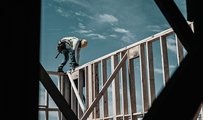 Worker constructing the frame of a new home at a residential housing development