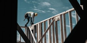 Worker constructing the frame of a new home at a residential housing development