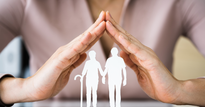 Image of a pair of hands forming a roof, with the silhouettes of an elderly couple superimposed below