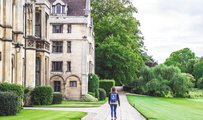 Woman walking past a University