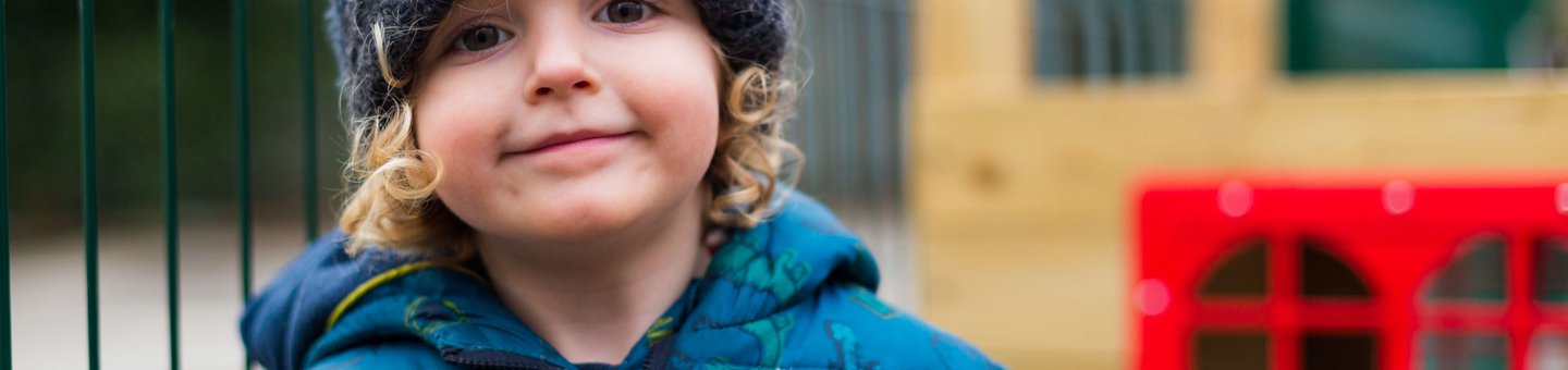 Young boy wearing a blue beanie and coat
