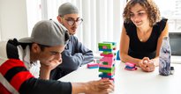 West London Zone benefactors playing jenga with their supervisor