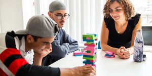West London Zone benefactors playing jenga with their supervisor