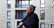 A tenant at the Campbell Wharf development laughing, facing to the right of the camera
