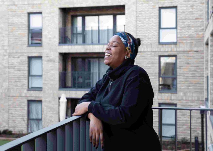 A tenant at the Campbell Wharf development laughing, facing to the right of the camera