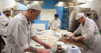 Group of chefs working in a bakery