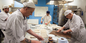 Group of chefs working in a bakery