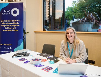 Member of Good Finance's staff sitting at event stand