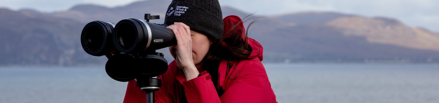 Woman looking through binoculars