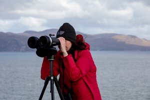 Woman looking through binoculars