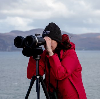 Woman looking through binoculars