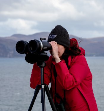 Woman looking through binoculars