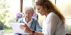 Carer sitting with an elderly woman