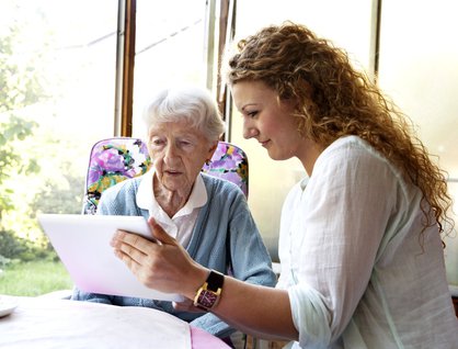 Carer sitting with an elderly woman