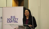 Rushanara Ali MP speaking at a lectern in front of a pop up banner which says 'Big Society Capital - Uniting capital, expertise and ideas for better lives'