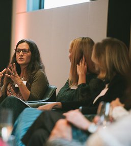 Four women talking on a panel