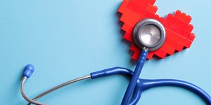 Image showing a stethoscope listening in to a heart which is made of Lego bricks