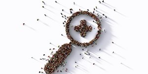 Birds eye view images which shows lots of people standing to form the shape of a magnifying glass