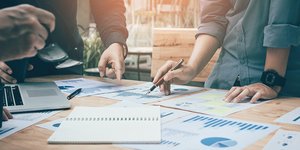 Two people looking at a graph