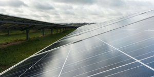 Side view on a solar panel on a solar panel farm