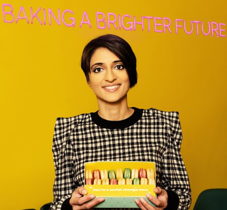 Rosie Ginday MBE holding a box of macaroons from her social enterprise, Miss Macaroon
