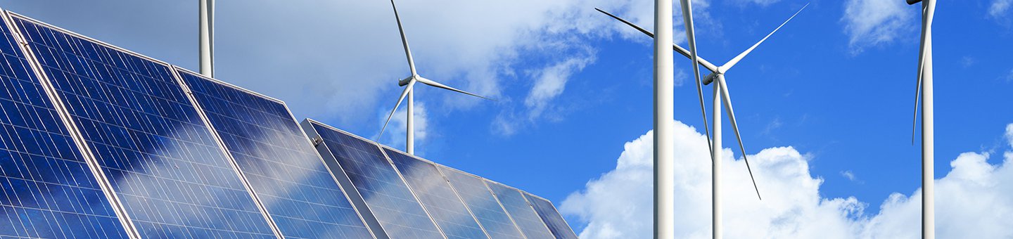 Solar panels and wind turbines on a field
