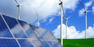 Solar panels and wind turbines on a field