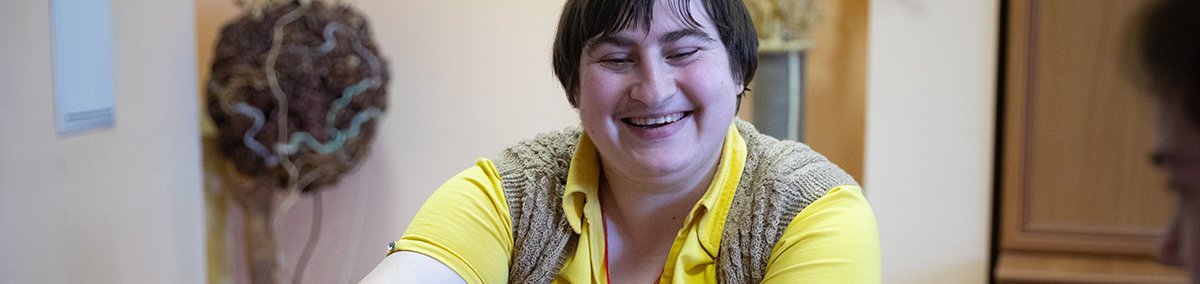 Woman smiling and doing crafts