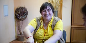 Woman smiling and doing crafts
