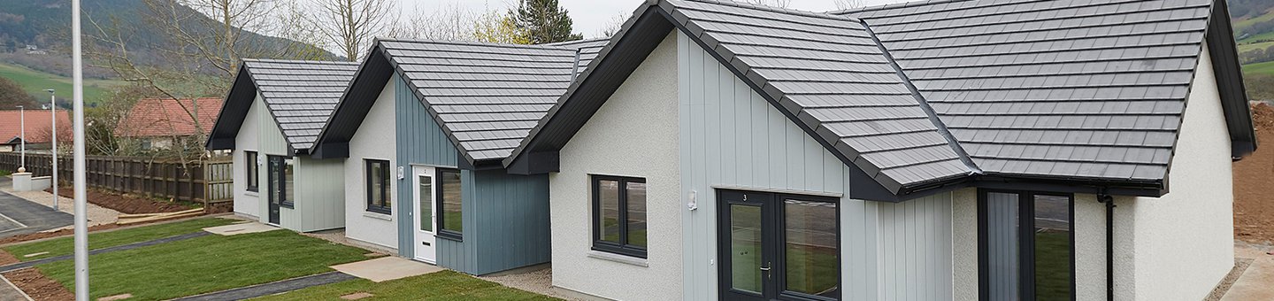Three white and grey bungalows