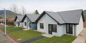 Three white and grey bungalows