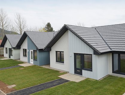 Three white and grey bungalows
