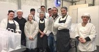 Group of chefs standing in a kitchen