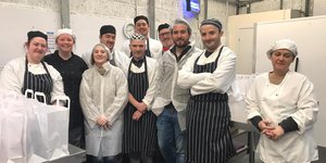 Group of chefs standing in a kitchen
