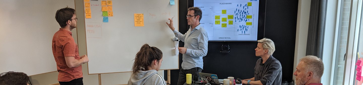 People talking infront of a whiteboard