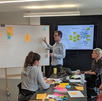 People talking infront of a whiteboard