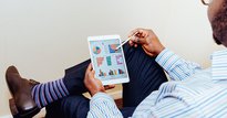 Man sat on a chair using a tablet
