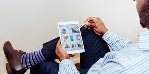 Man sat on a chair using a tablet