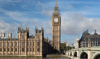 Image of ornate buildings including large clock tower from across a river