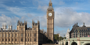 Image of ornate buildings including large clock tower from across a river