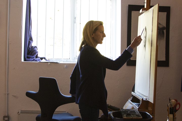Woman painting on a canvas