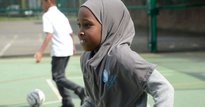 Girl in Hijab running in a playground
