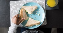 Hand picking up a sandwich
