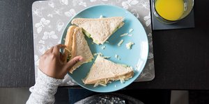 Hand picking up a sandwich