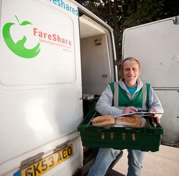 Man holding a crate of fresh bread