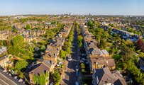 Image of a UK residential street with lots of trees taken from above