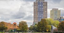 Image of high rise flats next to a park