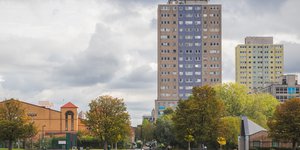 Image of high rise flats next to a park